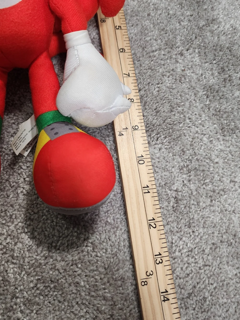 Red Plush Character Toy with White Gloves and Multicolor Shoes